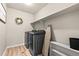 A modern laundry room offers a washer, dryer, shelving and folding space at 244 Chipeta Way, Lochbuie, CO 80603