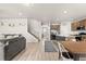 Open concept living room and dining area leading to the kitchen, all with beautiful hardwood floors at 244 Chipeta Way, Lochbuie, CO 80603
