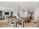 Open concept living space with large kitchen, dining area, living room with fireplace and backyard views at 244 Chipeta Way, Lochbuie, CO 80603