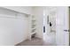 Walk-in closet features carpet flooring, white walls, and shelves for optimal storage solutions at 956 Andrews Crest Dr, Berthoud, CO 80513