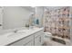 Functional bathroom with double sinks, a shower curtain, and a clean, modern design at 11783 Niagara St, Thornton, CO 80233