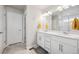 Modern bathroom with double sinks, stylish lighting, and a glass-enclosed shower at 11783 Niagara St, Thornton, CO 80233