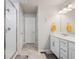 Well-lit bathroom featuring a glass shower, double sinks, and modern fixtures at 11783 Niagara St, Thornton, CO 80233