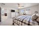 Bright bedroom featuring a plaid comforter, ceiling fan, and two windows offering natural light at 11783 Niagara St, Thornton, CO 80233