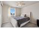 Neutral bedroom with a simple bed frame, natural light, and clean design at 11783 Niagara St, Thornton, CO 80233