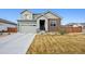 Inviting two-story home featuring a well-manicured lawn, a two-car garage, and an American flag displayed at 11783 Niagara St, Thornton, CO 80233