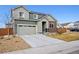 Charming two-story home featuring a two-car garage and a mix of siding and brick accents, set on a sunny lot at 11783 Niagara St, Thornton, CO 80233