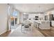 Open floor plan with kitchen island, dining area, stainless appliances and sliding doors to outside at 11783 Niagara St, Thornton, CO 80233