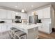 Modern kitchen featuring a quartz island, white subway tile backsplash, stainless steel appliances, and recessed lighting at 11783 Niagara St, Thornton, CO 80233