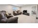 Spacious living room equipped with recliner seating and a modern entertainment center at 11783 Niagara St, Thornton, CO 80233