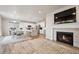 Spacious open-concept living area features a fireplace, a large TV, and seamless flow to the modern kitchen at 11783 Niagara St, Thornton, CO 80233