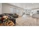 Bright living room showcases a comfortable sofa, large windows, and an adjacent dining area at 11783 Niagara St, Thornton, CO 80233