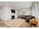 Comfortable living room featuring a fireplace, a large sectional sofa, and ample natural light through large windows at 11783 Niagara St, Thornton, CO 80233