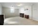 Unfinished basement space with neutral carpet and two small dark wood bedside tables for storage at 2695 S Josephine St, Denver, CO 80210