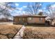 Charming brick home featuring a cozy front porch and mature trees in the front yard at 2695 S Josephine St, Denver, CO 80210