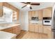Bright kitchen equipped with stainless steel appliances and wood cabinetry at 2695 S Josephine St, Denver, CO 80210
