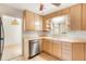 This kitchen offers a view from the corner sink, wood cabinets, and stainless steel dishwasher at 2695 S Josephine St, Denver, CO 80210