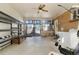 Enclosed sunroom with concrete floor, fan, shelving, and laundry machines with access to backyard at 2695 S Josephine St, Denver, CO 80210