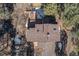 Birds eye view of house showing roof, deck, and surrounding snow covered forest with bare trees at 268 Cedar Rd, Golden, CO 80401