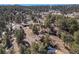 Aerial view shows a residence surrounded by trees in a rural landscape at 268 Cedar Rd, Golden, CO 80401