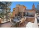 Spacious back deck features a dining table, chairs, and gas fire pit, perfect for outdoor entertaining at 268 Cedar Rd, Golden, CO 80401