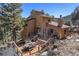 Rear exterior shot features wooden deck with a dining area, showcasing the outdoor living space at 268 Cedar Rd, Golden, CO 80401