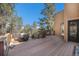 Expansive wooden deck offers ample space for outdoor gatherings, with seating, dining, and decorative accents at 268 Cedar Rd, Golden, CO 80401