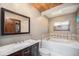 Bathroom featuring a tub, a skylight and vanity with a marble countertop at 268 Cedar Rd, Golden, CO 80401