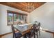 Dining room under wood ceiling with a large window, traditional chandelier, and seating for six at 268 Cedar Rd, Golden, CO 80401