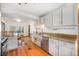 Bright kitchen with white cabinetry, granite counters, stainless appliances, tile backsplash and hardwood floors at 268 Cedar Rd, Golden, CO 80401