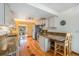 Kitchen featuring granite counters, stainless steel appliances, wood floors, eat in bar, and decorative accents at 268 Cedar Rd, Golden, CO 80401