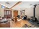 Well-lit living room features wood floors, wood beams, a wood-burning stove and a front door at 268 Cedar Rd, Golden, CO 80401