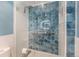 Sleek glass shower featuring blue mosaic tile and modern fixtures at 268 Cedar Rd, Golden, CO 80401