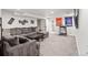 Cozy basement living room with large gray sectional sofa and sports-themed decor at 3241 Sheridan Blvd, Wheat Ridge, CO 80212