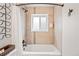 Modern bathroom featuring a bathtub with tiled surround and a shower head at 3241 Sheridan Blvd, Wheat Ridge, CO 80212