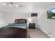 Bedroom featuring a dark wood bed frame, nightstand, small window, and wall-mounted TV at 3241 Sheridan Blvd, Wheat Ridge, CO 80212