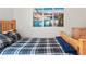 Bedroom featuring a wooden bed frame, mountain art, and wood dresser at 3241 Sheridan Blvd, Wheat Ridge, CO 80212