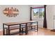 Dining area with wooden table and hardwood floors, illuminated by window light at 3241 Sheridan Blvd, Wheat Ridge, CO 80212