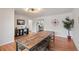 Bright dining room boasting hardwood floors and an extra long table for gathering at 3241 Sheridan Blvd, Wheat Ridge, CO 80212