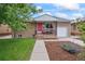 Charming brick home with a cozy front porch and well-maintained landscaping at 3241 Sheridan Blvd, Wheat Ridge, CO 80212