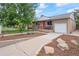 Charming brick home with a cozy front porch and well-maintained landscaping at 3241 Sheridan Blvd, Wheat Ridge, CO 80212