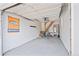 Clean garage interior featuring a staircase to upper level and storage shelves, with a Denver Broncos banner at 3241 Sheridan Blvd, Wheat Ridge, CO 80212