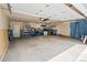 Spacious garage interior with ample storage shelving, pegboard walls, and overhead lighting at 3241 Sheridan Blvd, Wheat Ridge, CO 80212