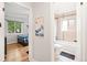 Hallway view with doors to the bathroom and a bedroom featuring hardwood floors at 3241 Sheridan Blvd, Wheat Ridge, CO 80212