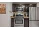Kitchen with stainless steel appliances, granite counters and dark cabinets at 3241 Sheridan Blvd, Wheat Ridge, CO 80212