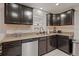 Kitchen with stainless steel appliances, granite counters and dark cabinets at 3241 Sheridan Blvd, Wheat Ridge, CO 80212