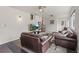 Inviting living room features plush seating, ceiling fan, and a decorative shelving unit on the staircase at 3241 Sheridan Blvd, Wheat Ridge, CO 80212