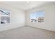 Bright bedroom featuring neutral carpeting, a ceiling light, and large windows at 3226 Belleville Ridge Rd, Elizabeth, CO 80107