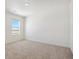 An airy bedroom featuring neutral carpeting, a ceiling light, and a large window at 3226 Belleville Ridge Rd, Elizabeth, CO 80107