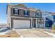 Charming two-story home features a large driveway, two-car garage, and covered front porch at 3226 Belleville Ridge Rd, Elizabeth, CO 80107